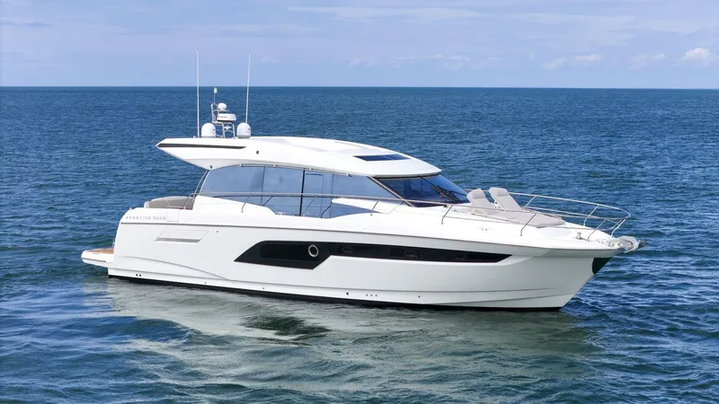 Slide: The Image of 2019 Prestige 520S yacht cruising on open sea under clear skies. - 3