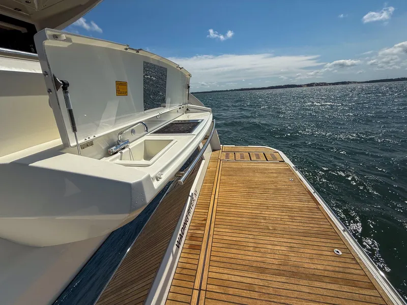 Slide: The Image of 2019 Prestige 520S yacht with open deck and sink, overlooking serene ocean waters. - 30