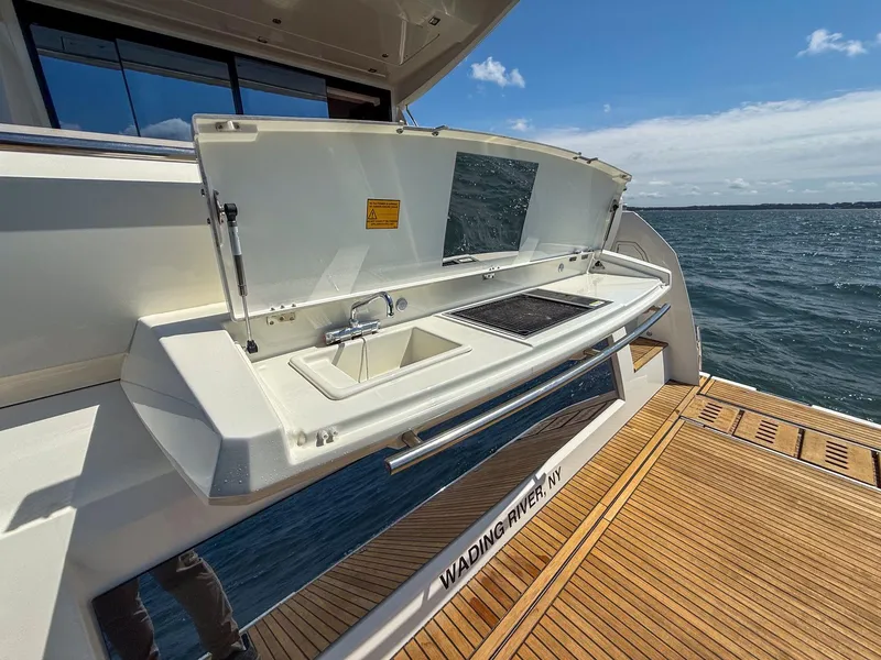 Slide: The Image of 2019 Prestige 520S yacht with outdoor kitchen, sink, and grill on deck by the sea. - 31