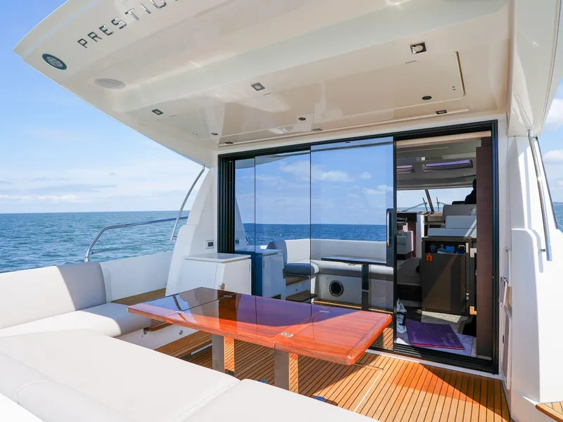 Slide: The Image of 2019 Prestige 520S yacht with spacious deck, glass doors, and ocean view. - 32