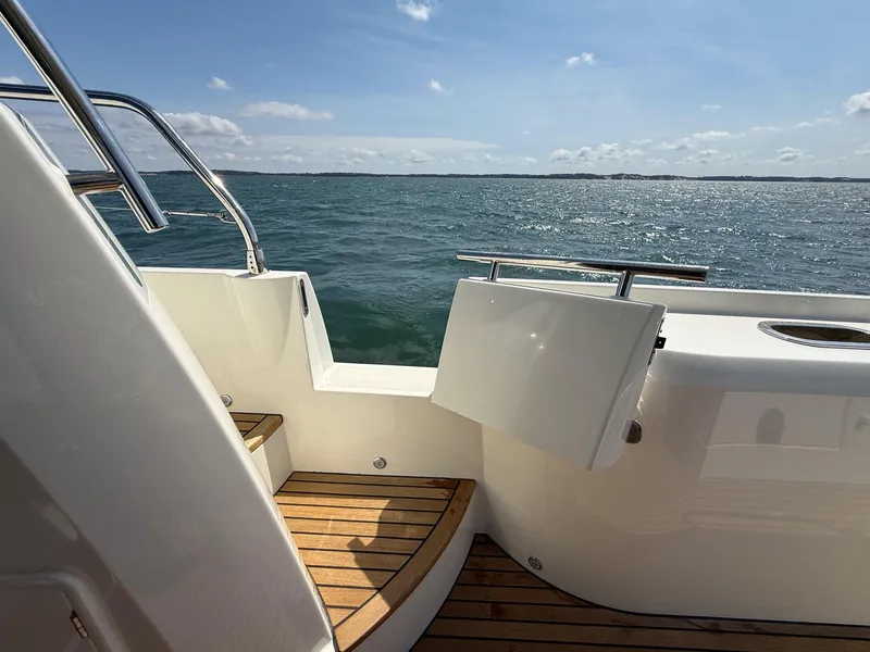 Slide: The Image of 2019 Prestige 520S yacht deck with ocean view, featuring wooden steps and railing. - 36