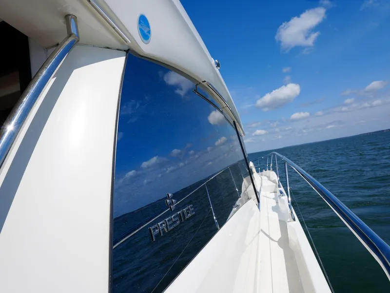 Slide: The Image of 2019 Prestige 520S yacht reflecting ocean and sky, showcasing sleek design and luxury. - 38
