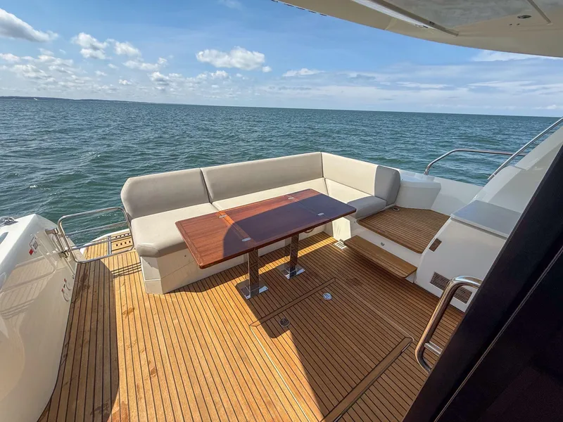 Slide: The Image of Luxury 2019 Prestige 520S yacht deck with seating and ocean view. - 39
