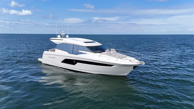 Slide: The Image of 2019 Prestige 520S yacht cruising on open sea under clear blue sky. - 4