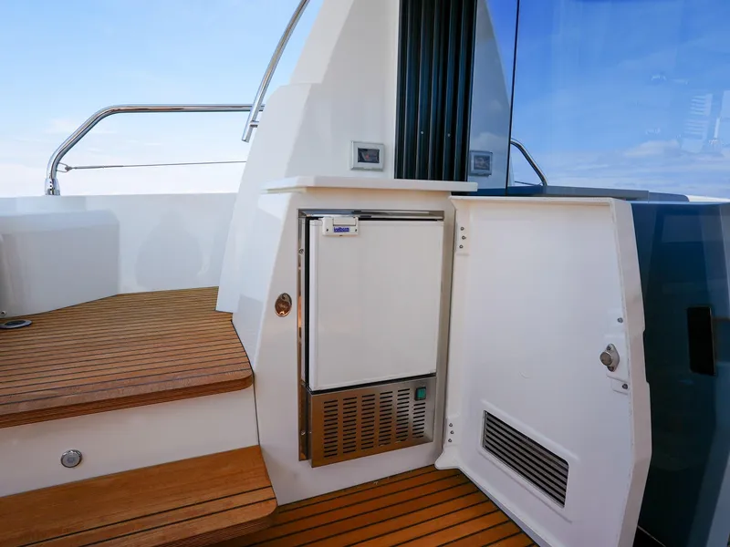 Slide: The Image of 2019 Prestige 520S yacht interior with wooden steps and built-in mini fridge. - 42