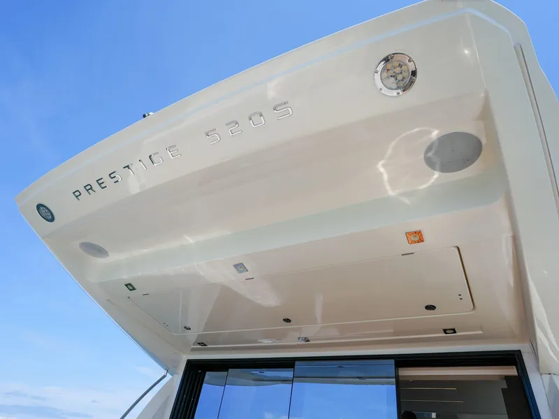 Slide: The Image of 2019 Prestige 520S yacht exterior with sleek design and modern features under a clear blue sky. - 43