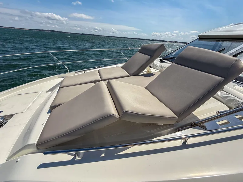 Slide: The Image of Luxurious 2019 Prestige 520S yacht with sun loungers on deck, cruising on open water. - 48