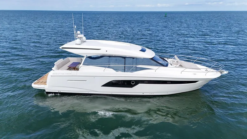 Slide: The Image of 2019 Prestige 520S yacht cruising on open sea under clear skies. - 5