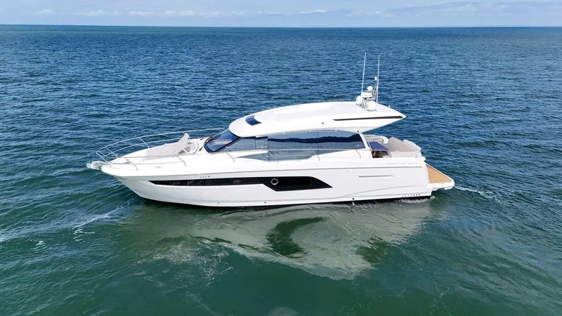 Slide: The Image of 2019 Prestige 520S yacht cruising on open sea under clear skies. - 6