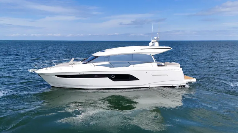 Slide: The Image of 2019 Prestige 520S yacht cruising on open sea under clear skies. - 7