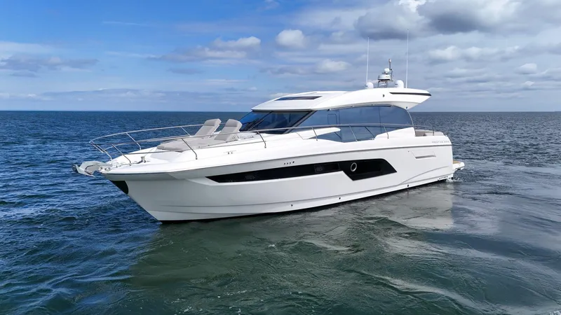 Slide: The Image of 2019 Prestige 520S yacht cruising on open water under a cloudy sky. - 8