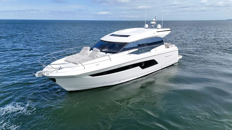 Slide: The Image of 2019 Prestige 520S yacht cruising on open sea under clear skies. - 9