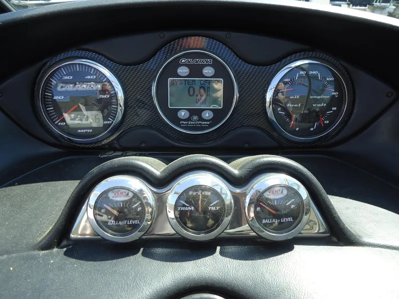 Slide: The Image of Dashboard of a 2009 Calabria Pro V II boat with gauges and controls. - 10