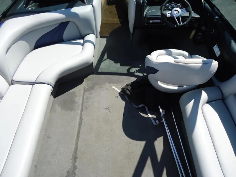 Slide: The Image of Interior of a 2009 Calabria Pro V II boat with white seating and steering wheel. - 2