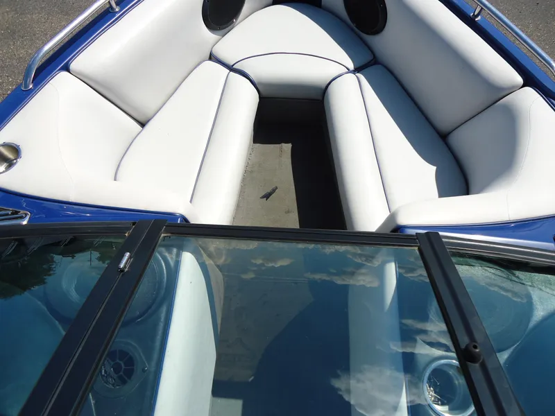 Slide: The Image of 2009 Calabria Pro V II boat interior with white seating and blue accents. - 3