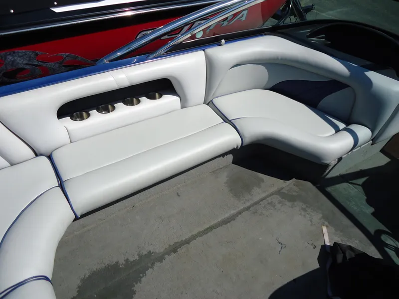 Slide: The Image of 2009 Calabria Pro V II boat interior with white seating and cup holders. - 4
