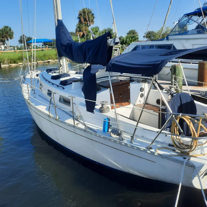 The Image of 1984 Cheoy Lee Sloop sailboat docked in a marina, featuring blue covers and clear skies. - 0