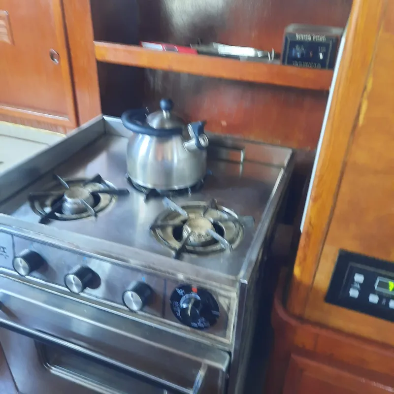 Slide: The Image of Galley kitchen in 1984 Cheoy Lee Sloop with stove and kettle. - 16