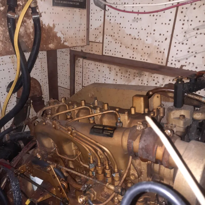 Slide: The Image of Engine room of a 1984 Cheoy Lee Sloop, showcasing mechanical components and wiring. - 18