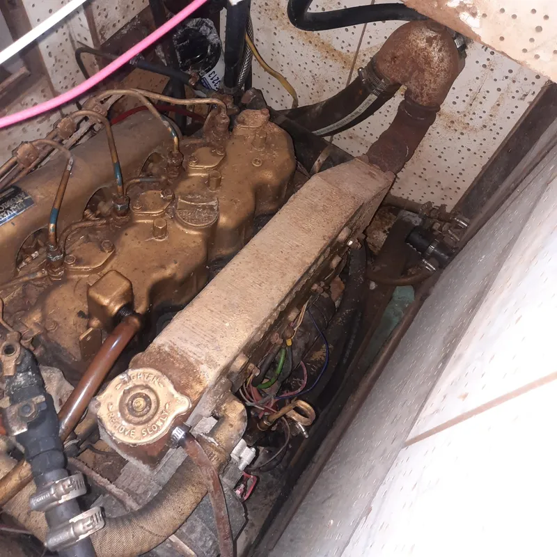 Slide: The Image of Engine compartment of a 1984 Cheoy Lee Sloop, showing mechanical components and wiring. - 19