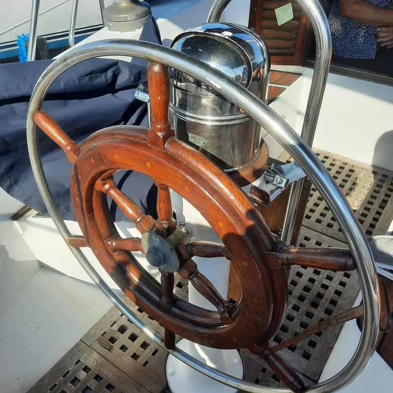 Slide: The Image of Wooden steering wheel on a 1984 Cheoy Lee Sloop sailboat deck. - 6