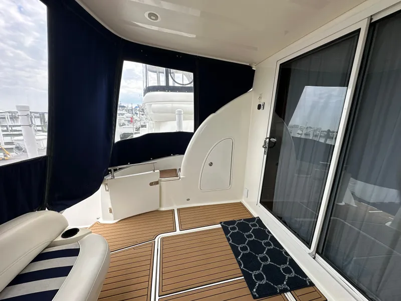 Slide: The Image of 2008 Meridian 391 Sedan yacht interior with wood flooring and navy curtains. - 10