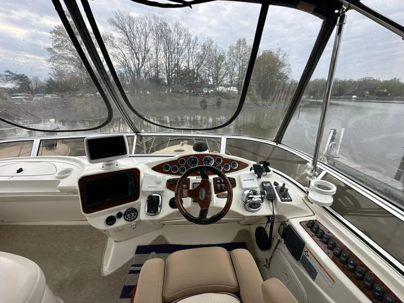 Slide: The Image of 2008 Meridian 391 Sedan helm with steering wheel, navigation controls, and panoramic water view. - 12