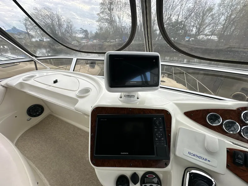 Slide: The Image of 2008 Meridian 391 Sedan helm with navigation screens and controls, featuring a spacious cockpit view. - 13