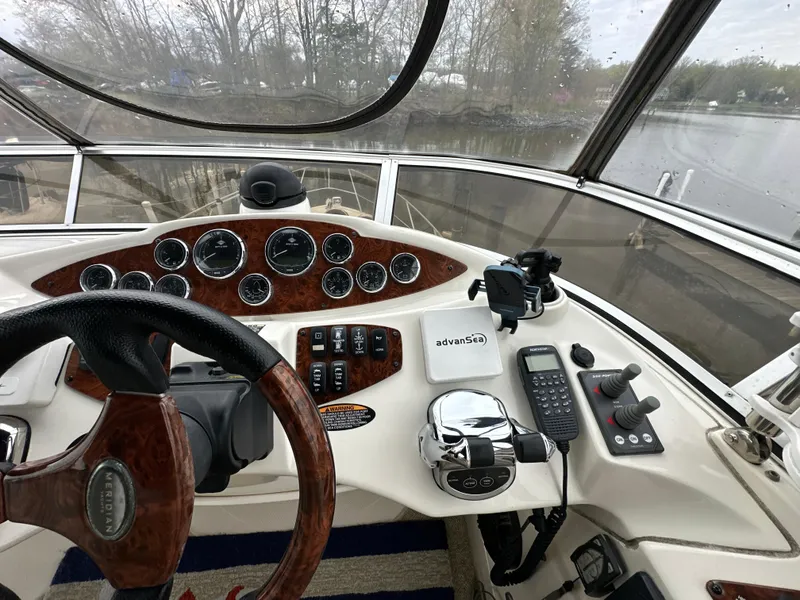 Slide: The Image of 2008 Meridian 391 Sedan helm with wood accents, steering wheel, and control panel. - 14