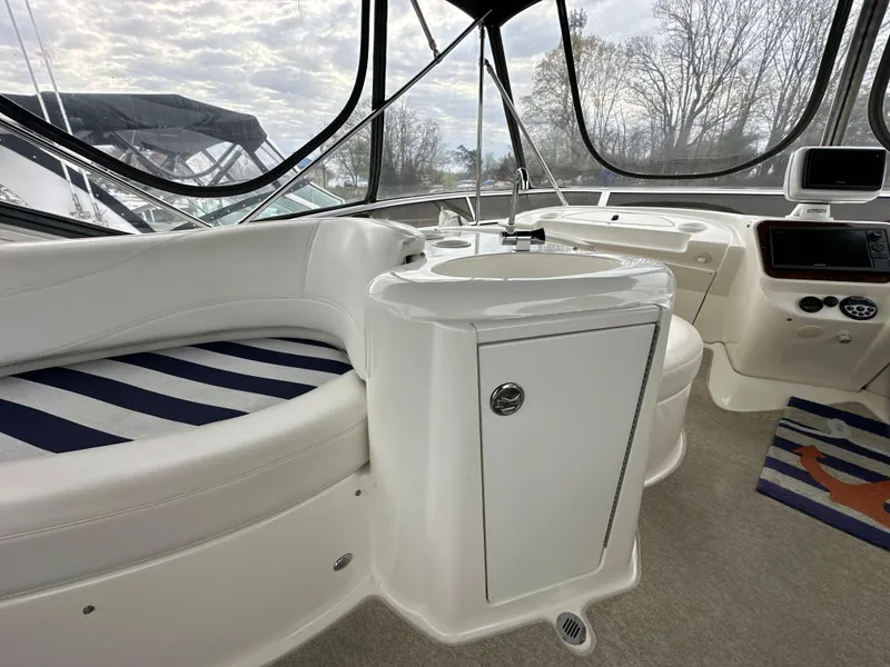 Slide: The Image of 2008 Meridian 391 Sedan interior with white seating, striped cushions, and a compact sink area. - 19