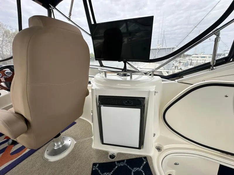 Slide: The Image of Captain's chair and console on 2008 Meridian 391 Sedan yacht, featuring a mounted screen. - 20