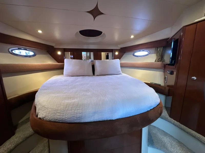 Slide: The Image of Luxurious interior of 2008 Meridian 391 Sedan yacht with cozy bed and elegant wood finish. - 32