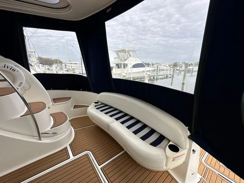Slide: The Image of 2008 Meridian 391 Sedan interior with striped seating and wooden flooring, docked at a marina. - 9