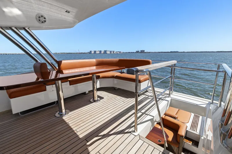 Slide: The Image of 2013 Cheoy Lee 76 Alpha yacht deck with seating, overlooking calm waters. - 10