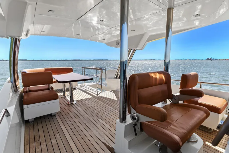Slide: The Image of Luxurious 2013 Cheoy Lee 76 Alpha yacht deck with brown seating and ocean view. - 12