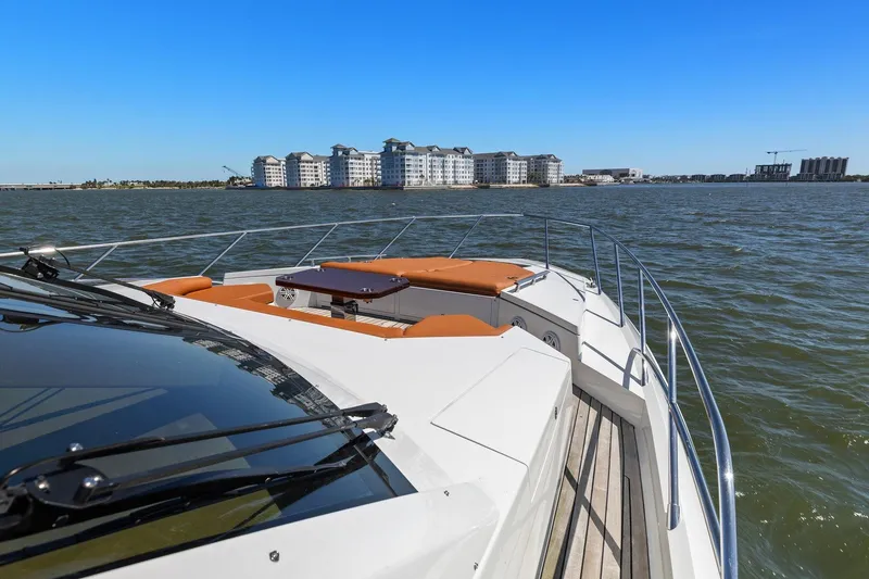 Slide: The Image of 2013 Cheoy Lee 76 Alpha yacht cruising on open water with cityscape in background. - 15