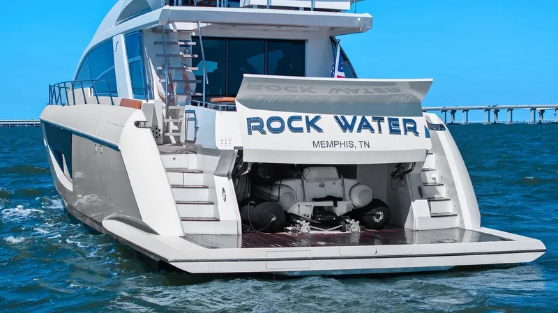 Slide: The Image of 2013 Cheoy Lee 76 Alpha yacht on water, rear view with open garage. - 25