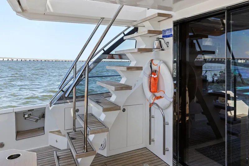 Slide: The Image of Staircase on 2013 Cheoy Lee 76 Alpha yacht, overlooking serene ocean view. - 26