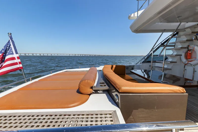 Slide: The Image of Luxurious 2013 Cheoy Lee 76 Alpha yacht with sun deck and American flag on open water. - 27