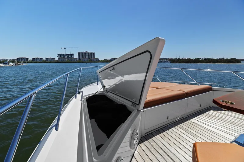 Slide: The Image of 2013 Cheoy Lee 76 Alpha yacht with open hatch and sunbathing deck on calm water. - 4