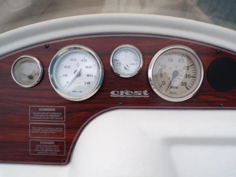 Slide: The Image of Dashboard of 2000 Crest II DL boat with gauges and wood paneling. - 10
