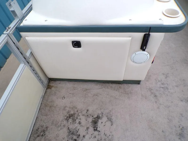 Slide: The Image of Crest II DL 2000 boat interior with storage compartment and speaker. - 15