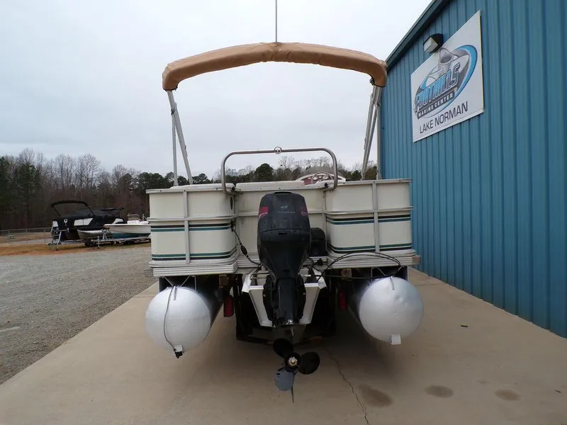 Slide: The Image of Rear view of a 2000 Crest II DL pontoon boat at a marina. - 4