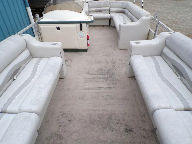 Slide: The Image of 2000 Crest II DL pontoon boat interior with spacious seating and helm. - 7