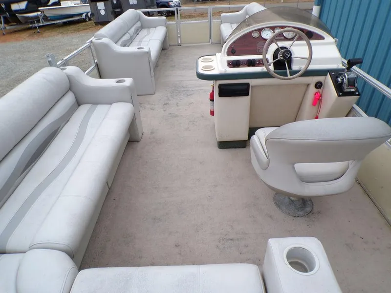 Slide: The Image of Interior of a 2000 Crest II DL pontoon boat with seating and steering console. - 8