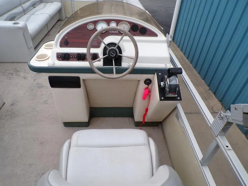 Slide: The Image of 2000 Crest II DL boat helm with steering wheel, controls, and seating. - 9