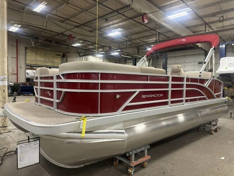 Slide: The Image of 2025 Bennington S Swingback 22 SSB pontoon boat in a warehouse setting. - 11