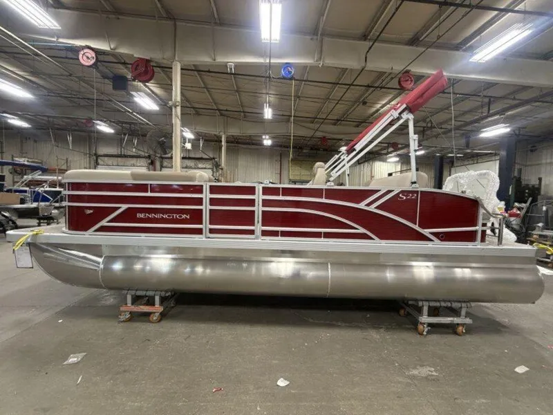 Slide: The Image of 2025 Bennington S Swingback 22 SSB pontoon boat in a warehouse setting. - 12