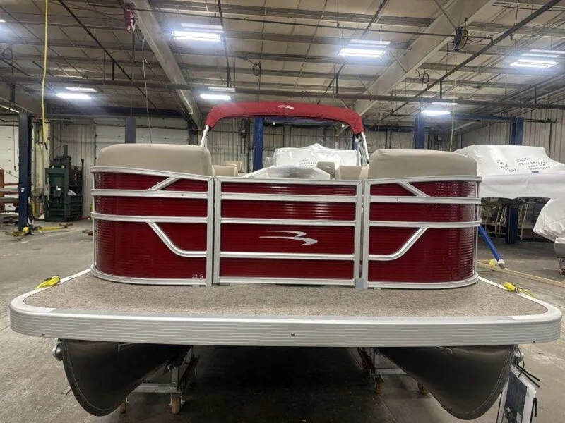 Slide: The Image of 2025 Bennington S Swingback 22 SSB pontoon boat in a warehouse setting. - 13