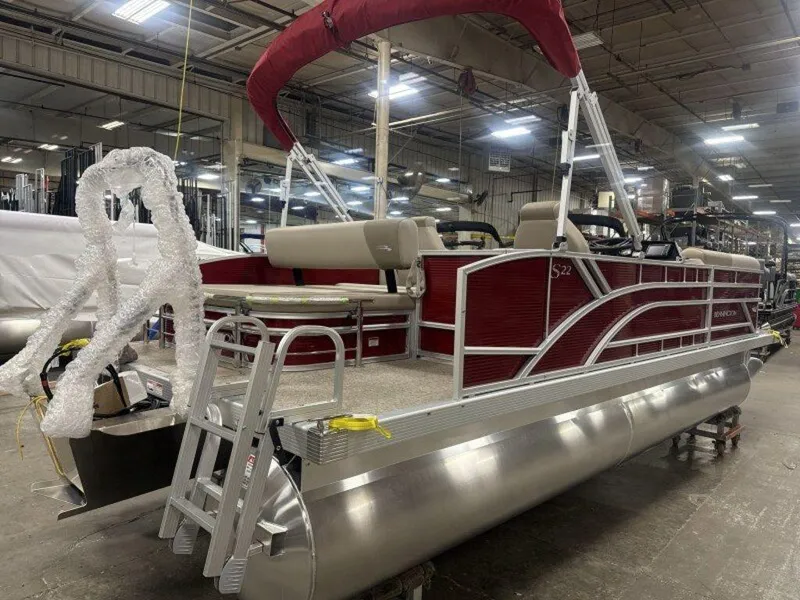 Slide: The Image of 2025 Bennington S Swingback 22 SSB pontoon boat in a warehouse setting. - 14